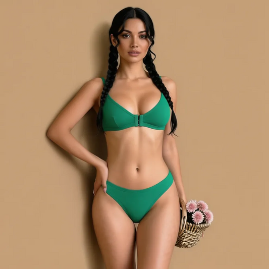 Woman in a green bikini holding flowers against a beige background