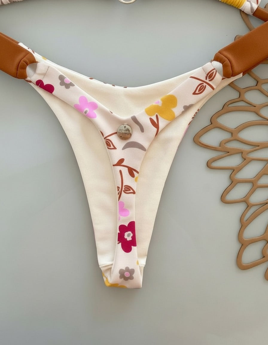 Floral-patterned panty on a hanger against a neutral background