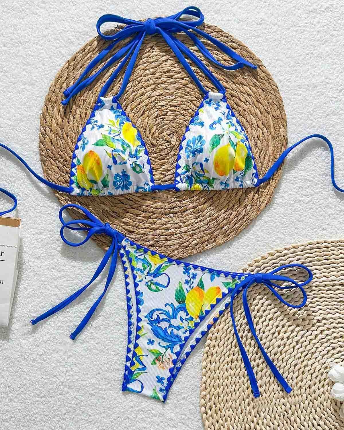 Bikini set with floral and lemon design on a textured surface